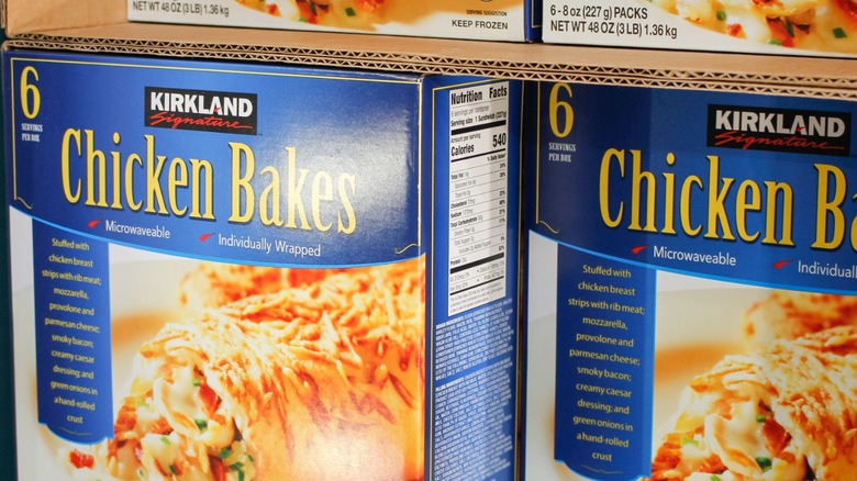 Frozen Costco chicken bake packages on a freezer shelf in the store.