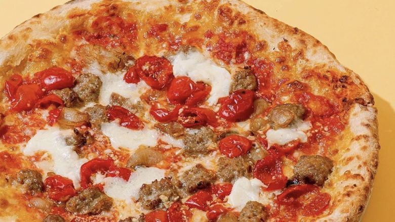 A pizza served on a metal platter at Antico Pizza Napoletana in Atlanta