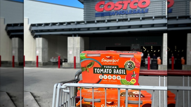 Packages of Soupergirl soup in a shopping cart in front of Costco