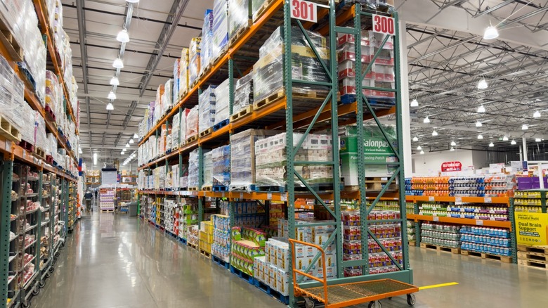 The interior of a Costco warehouse store with aisles stacked high with bulk goods.
