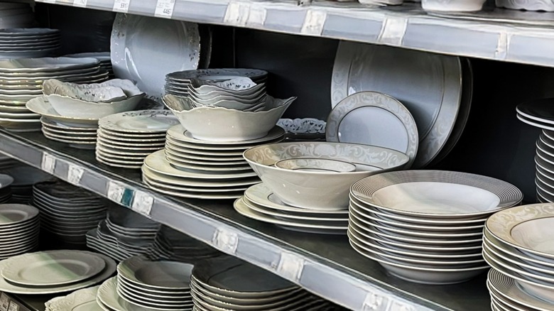 Different solid-colored dinnerware displayed on a store shelf