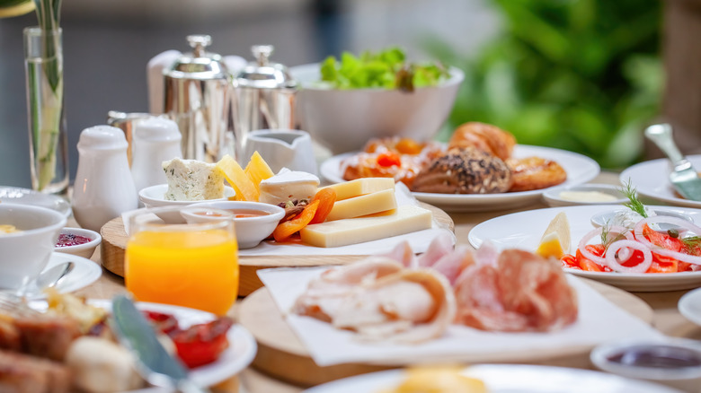 A brunch spread with neatly plated dishes of charcuterie and more