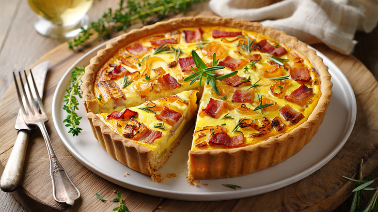 A plate of quiche Lorraine perfectly presentable on a white plate