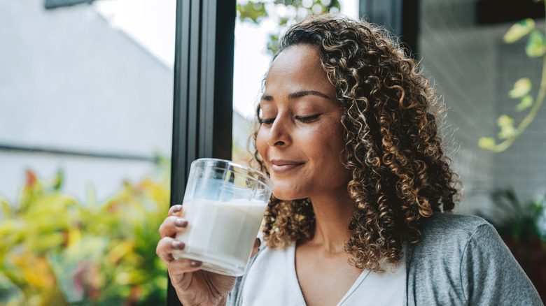 A person enjoying a glass of milk.