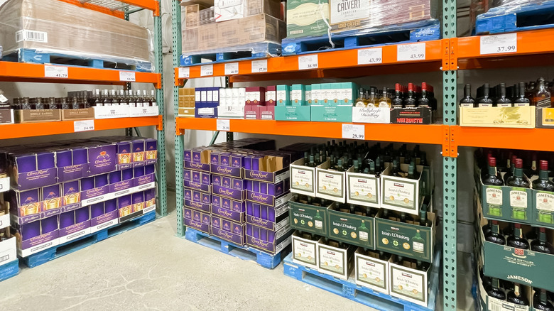 Costco whiskey options in warehouse store on bulk shelves.