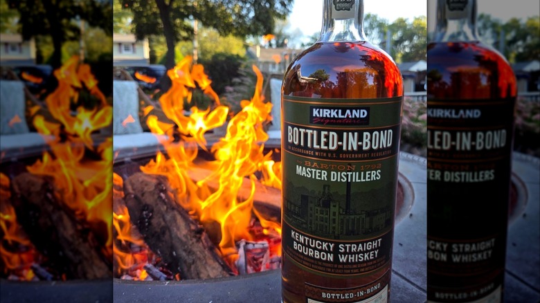 Kirkland Bottled-in-Bond Bourbon by roaring fire in residential area.
