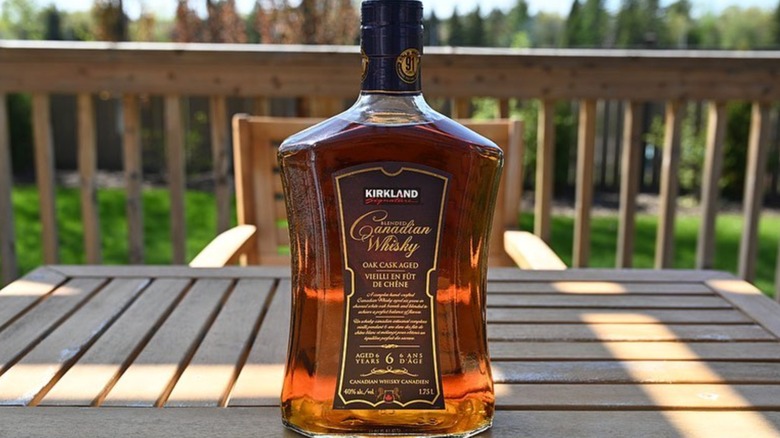 Kirkland Signature Canadian Whisky bottle on wood table in residential home.