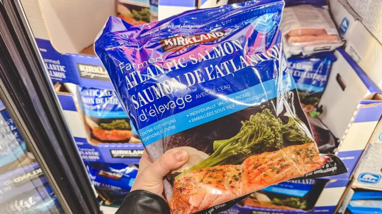 Person holding Costco Kirkland Signature frozen Atlantic salmon