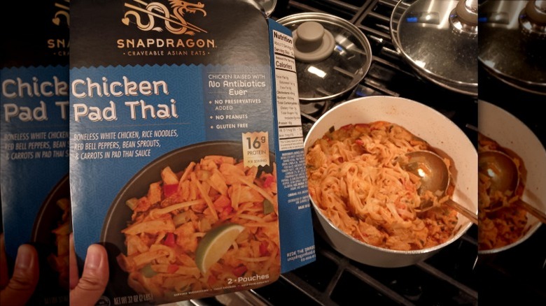 A person holding a package of Snapdragon Chicken Pad Thai next to a bowl holding the finished dish