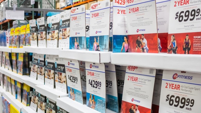 Discount deals on tickets and gym memberships shown in a display at Costco.