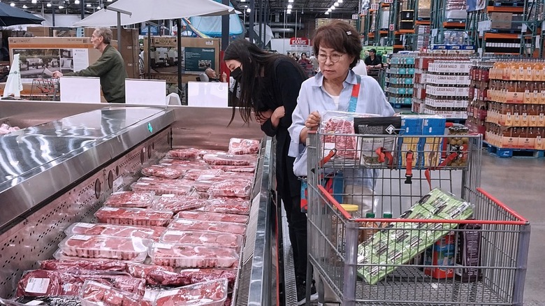 Woman shopping in Costco's meat case