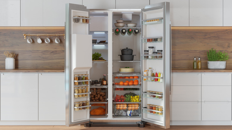 Open refrigerator in a kitchen with food inside