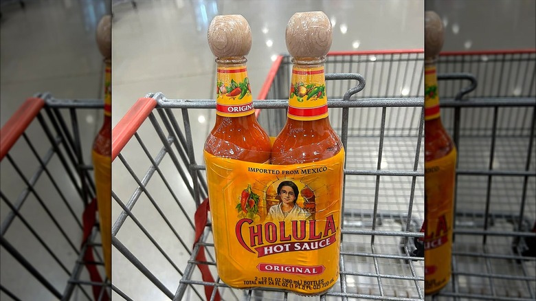 Two-pack of Cholula Hot Sauce in a grocery cart at Costco.