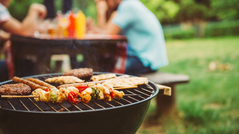 Barbecued meat rests on an outdoor grill
