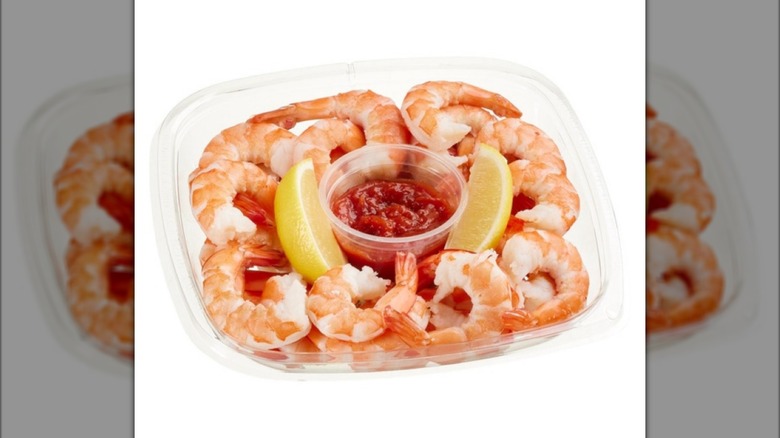 The Kirkland Signature Shrimp Cocktail with Cocktail Sauce & Lemon from Costco on white background