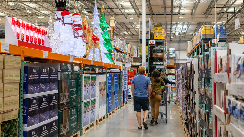 Customers walking down an aisle with Christmas items at Costco