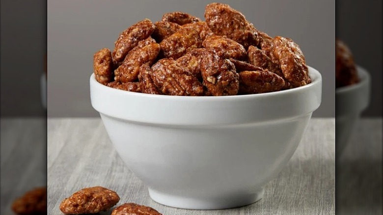 A white bowl filled with praline pecans
