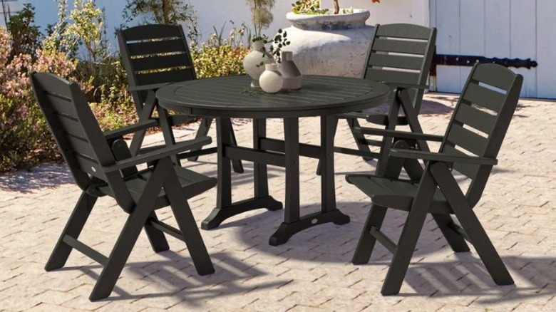 Polywood Chesapeake folding dining set in black sitting on a patio.