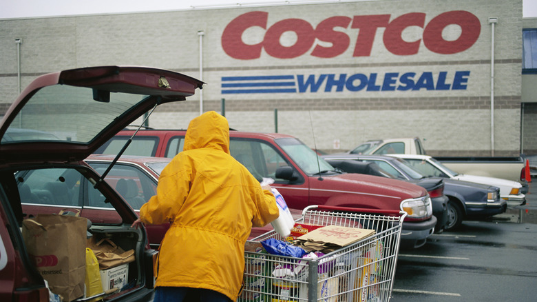 Costco shopper unloading a cart