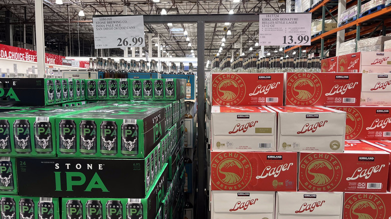 A Stone IPA beer display alongside a Kirkland Lager beer display at Costco.