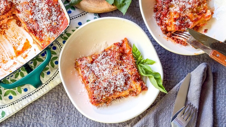 Cottage cheese lasagna slices in bowls with fresh basil