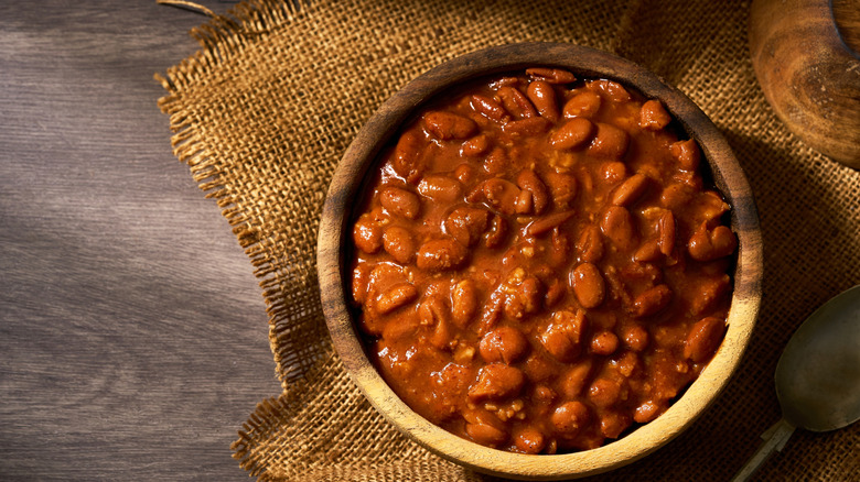 Bowl of cowboy beans in a wooden bowl