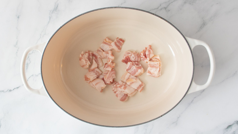 chopped raw bacon in a white pot