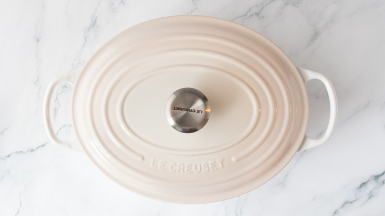 white oval pot with a white lid