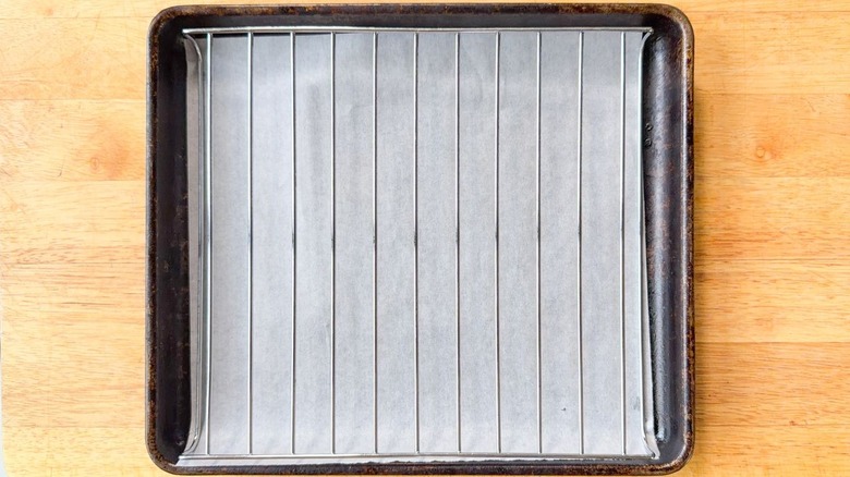 Parchment-lined baking sheet fitted with a rack