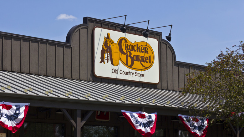 The exterior of a Cracker Barrel restaurant on a sunny day