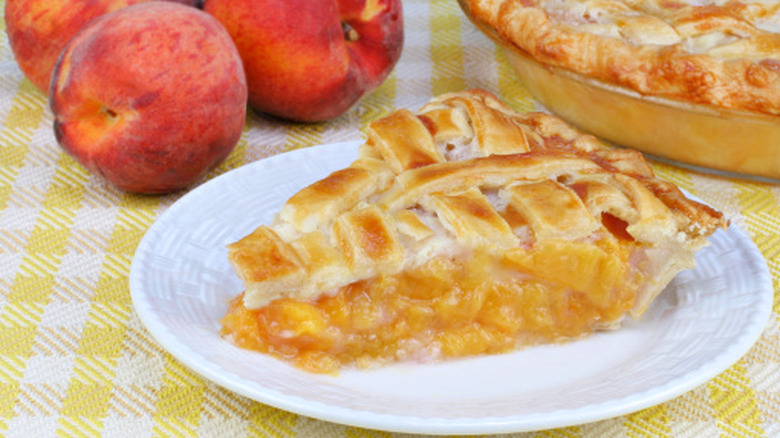 a slice of peach pie on a plate