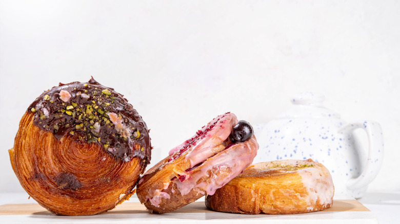 Three supreme croissants with various fillings and toppings