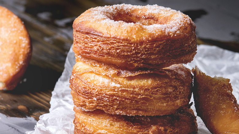 Stack of homemade Cronuts on white parchment paper