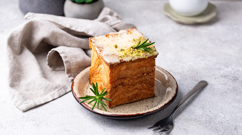 Cube shaped croissant with sprig of rosemary on top
