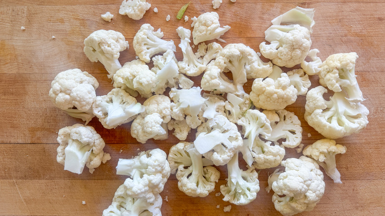 Cauliflower florets on wooden board
