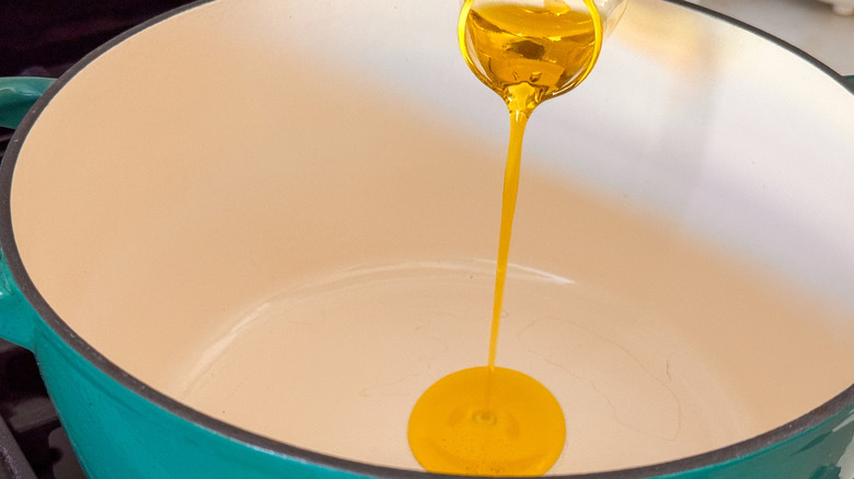 oil pouring in soup pot