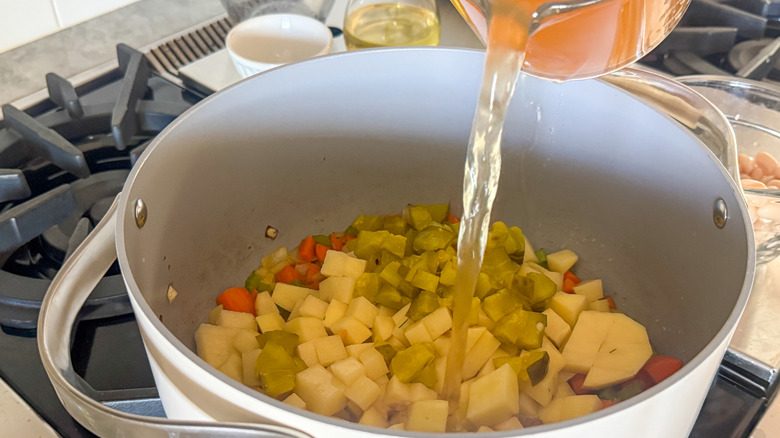 broth pouring into pot