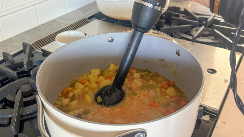 hand using immersion blender