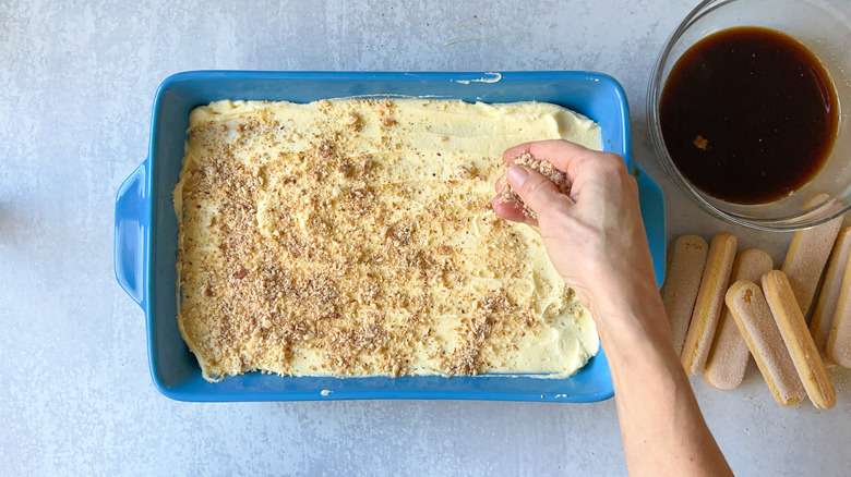 sprinkling hazelnuts over mascarpone cream