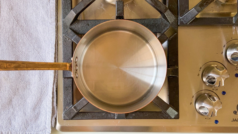 Saucepan with water on stove for water bath