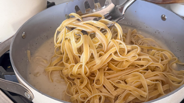 Fettuccine pasta in pan with creamy sauce