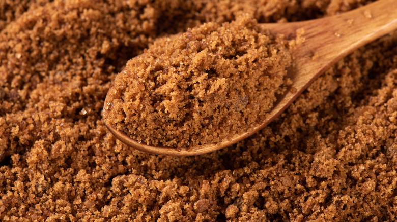 brown sugar in a wooden spoon.