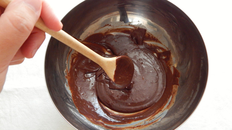 mixing together hot fudge in a bowl