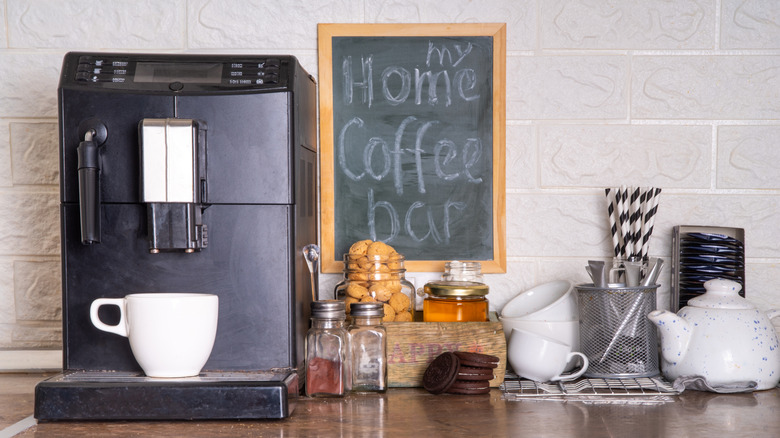 A home coffee bar set up complete with cute straws, pastries and a chalkboard sign