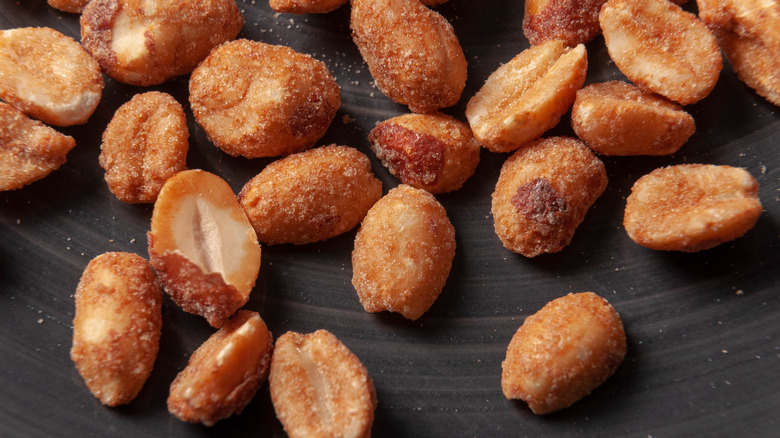 Candied pecans on black surface