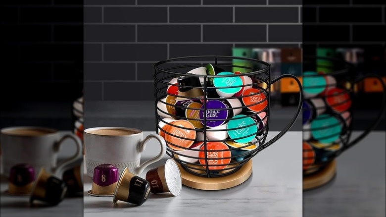 Coffee pod holder with colorful pods and cup of coffee