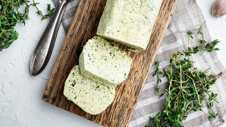 Homemade compound butter long on a wooden board