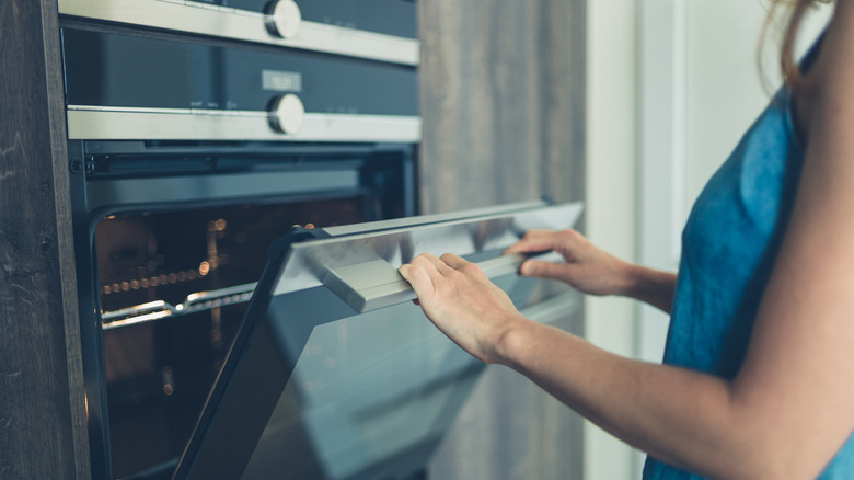 Person opening up an oven