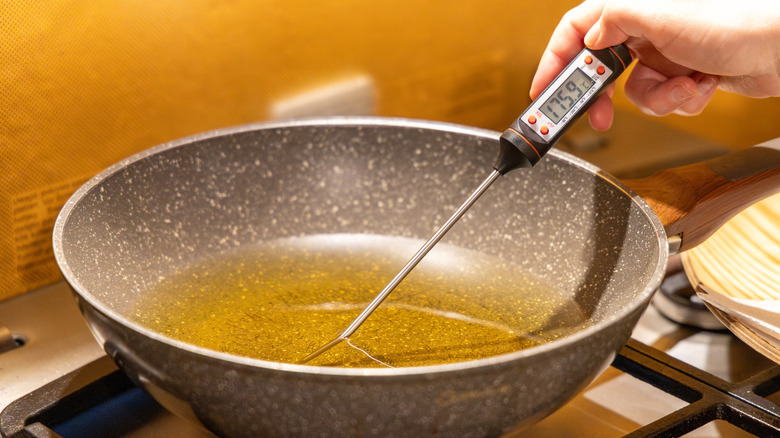Heating up a frying pan with oil and thermometer