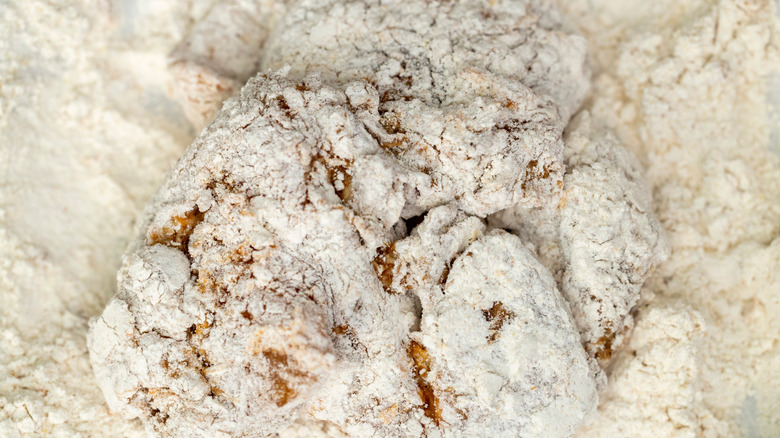 Raw chicken sitting in breading